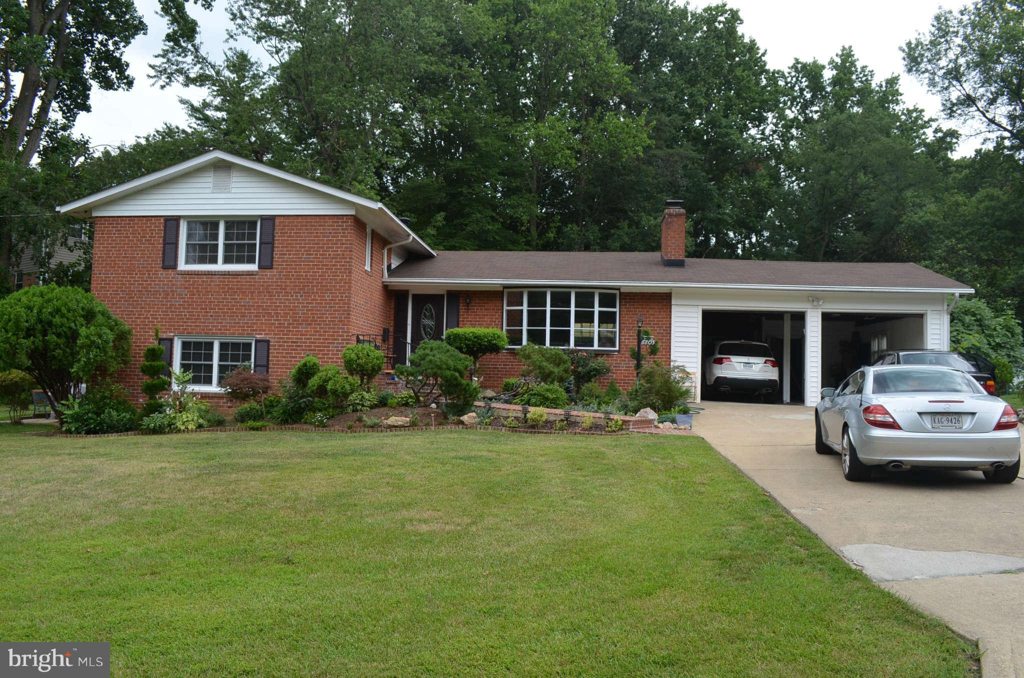 a front view of a house with a yard and porch