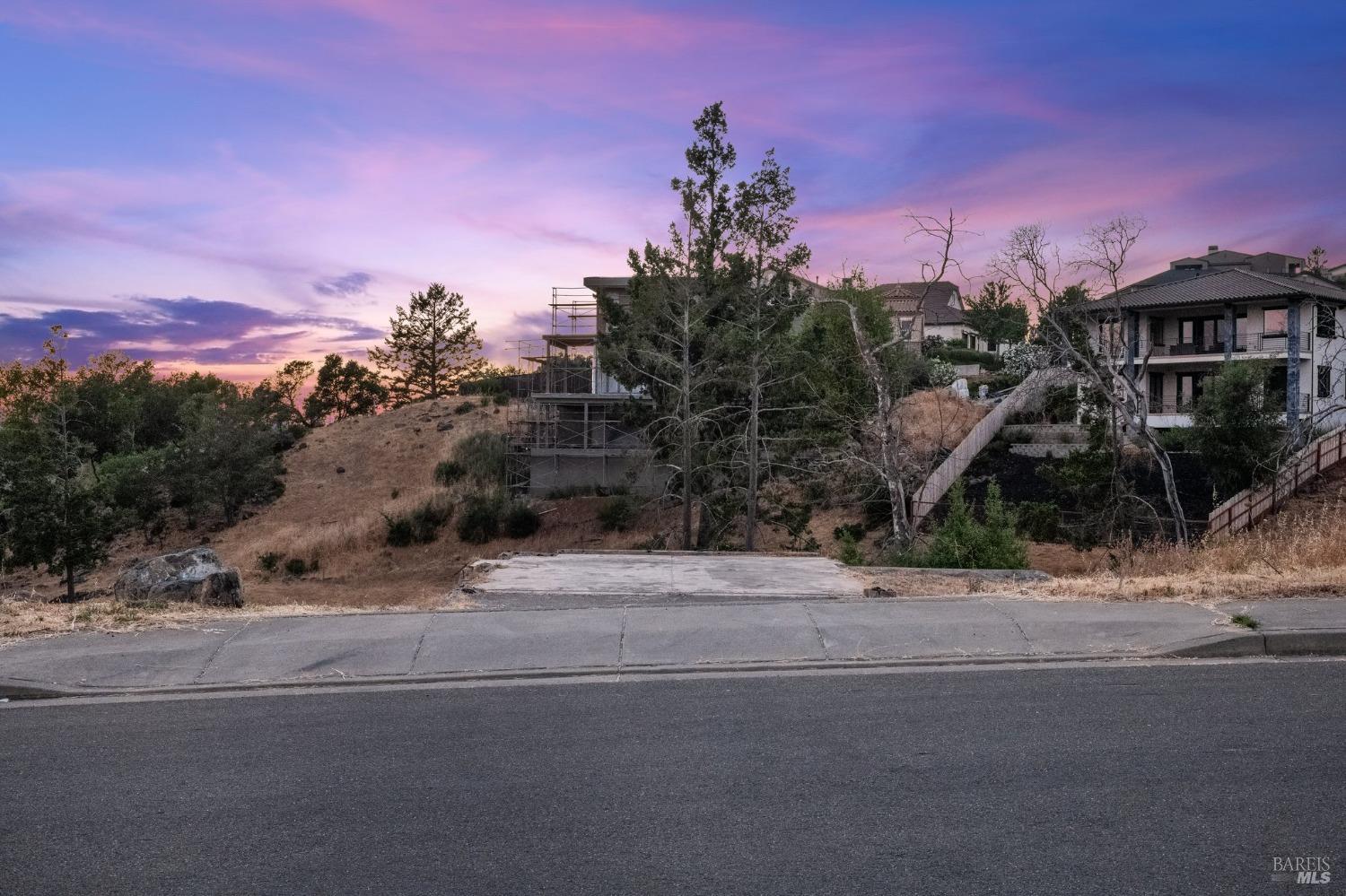 a front view of a house with a yard and mountain view