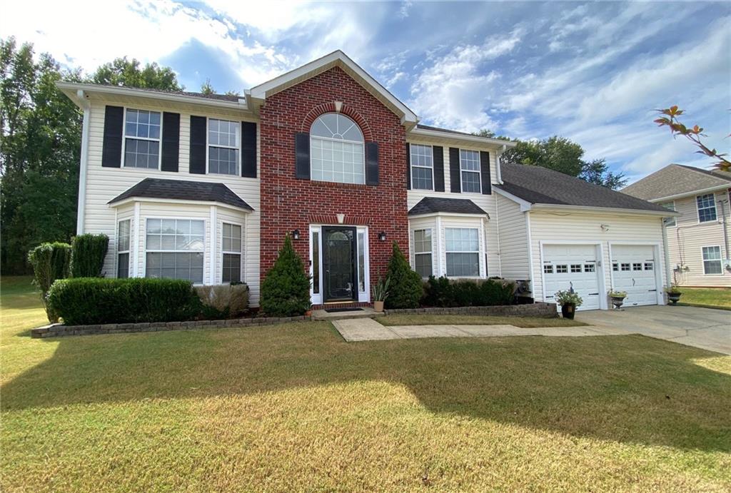 a front view of a house with a yard