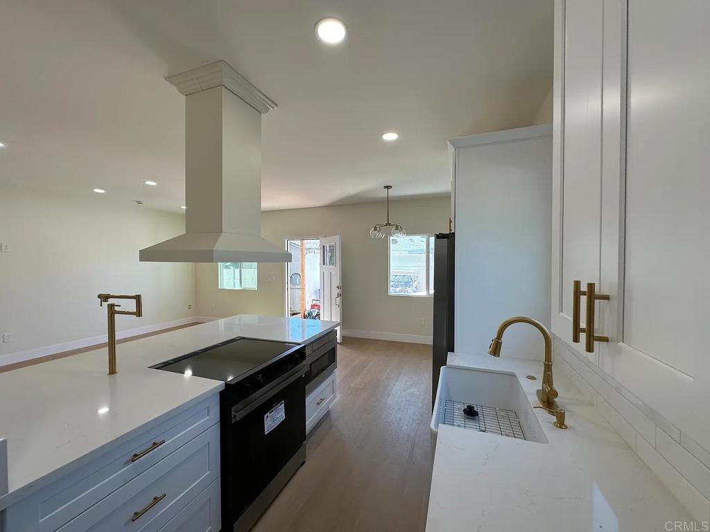 a kitchen with granite countertop a stove and a sink