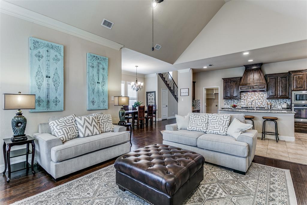 a living room with furniture and a view of kitchen