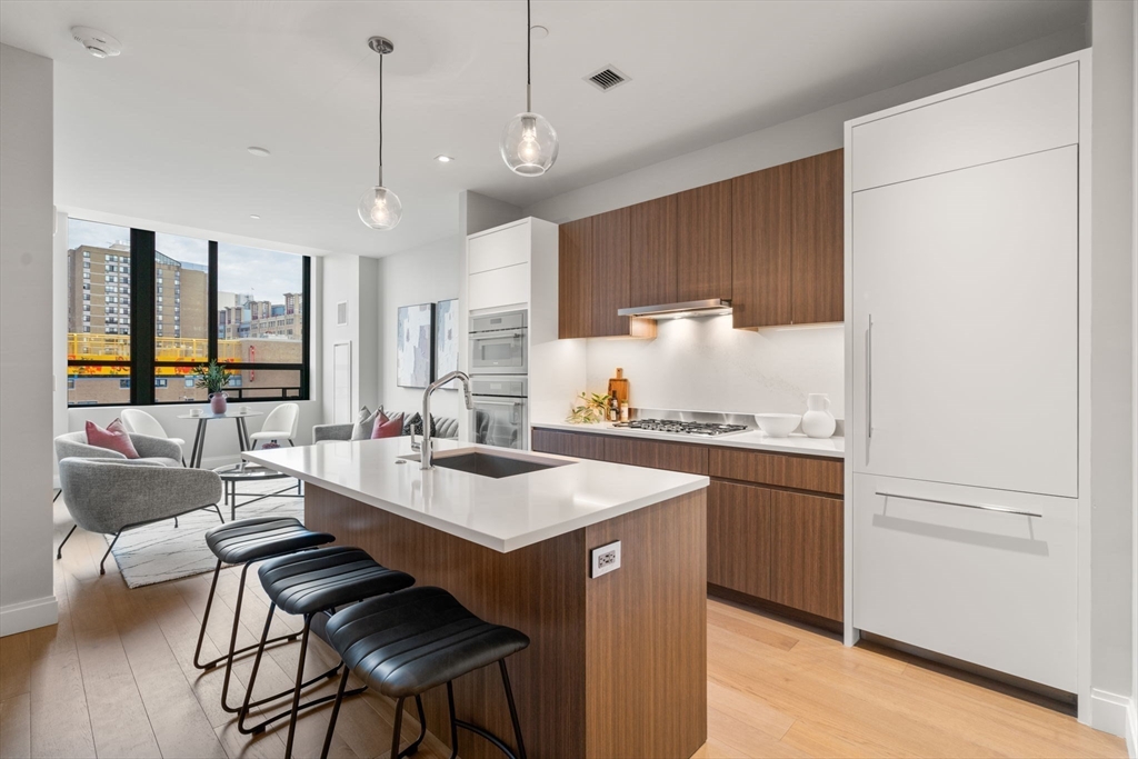 a kitchen with a sink a stove a dining table and chairs