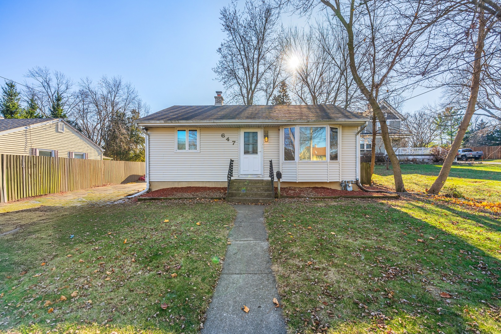 a view of a house with backyard and a tree