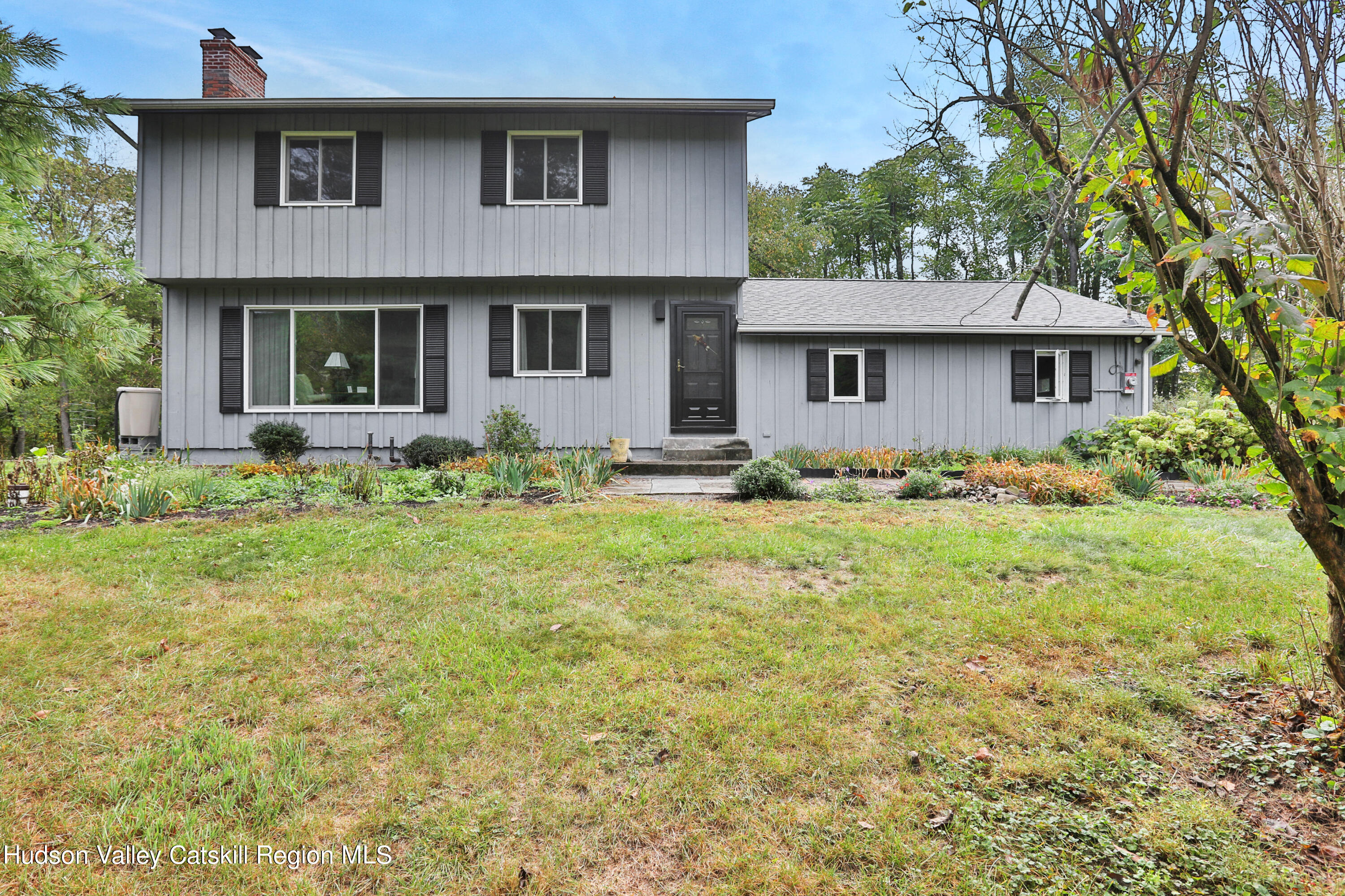 a front view of a house with garden