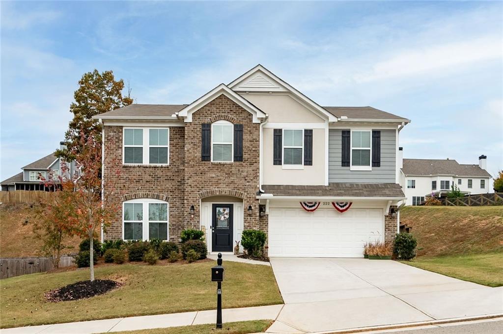 a front view of a house with garage