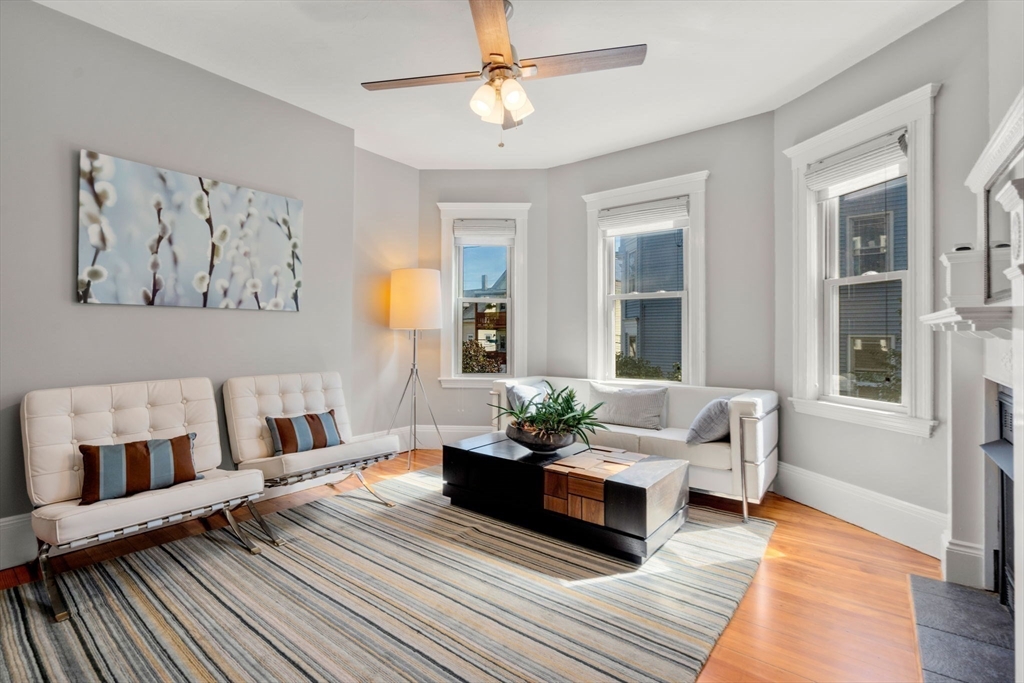 a living room with furniture and wooden floor