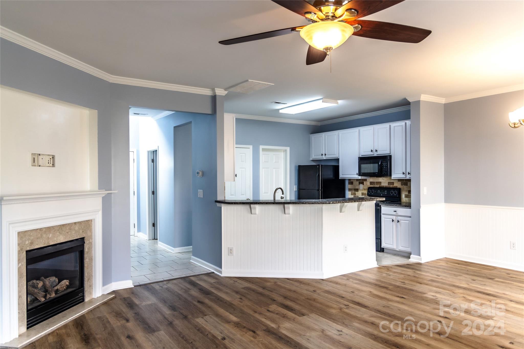 a kitchen with kitchen island a sink stainless steel appliances and window