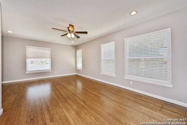 a view of a livingroom with a ceiling fan and window