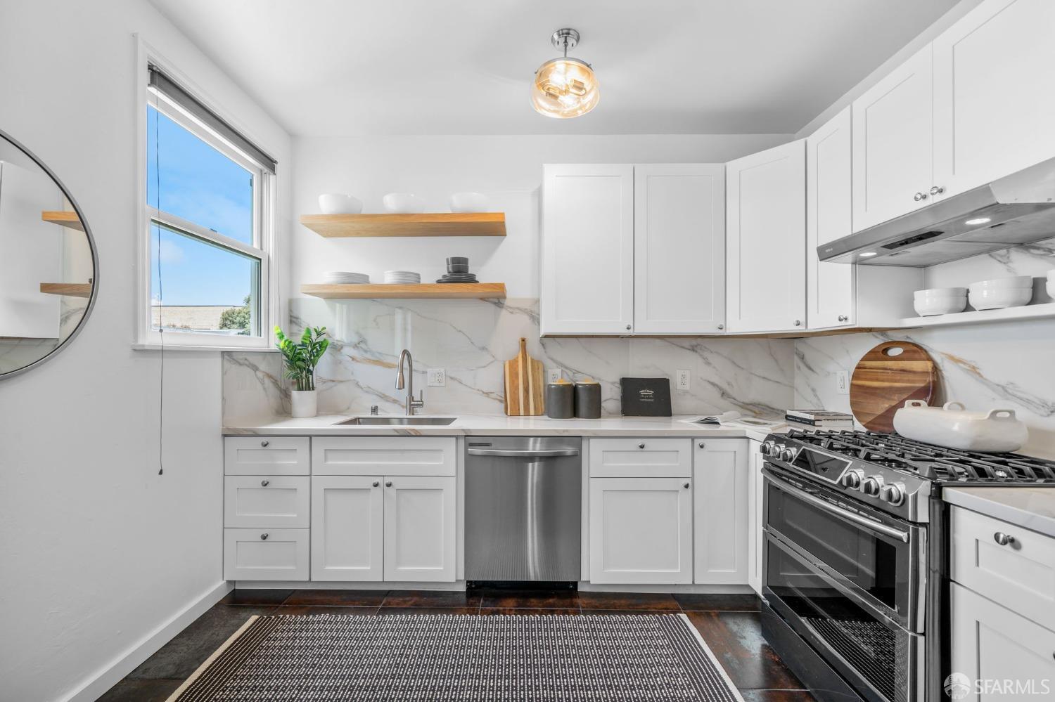 a kitchen with granite countertop a stove and cabinets