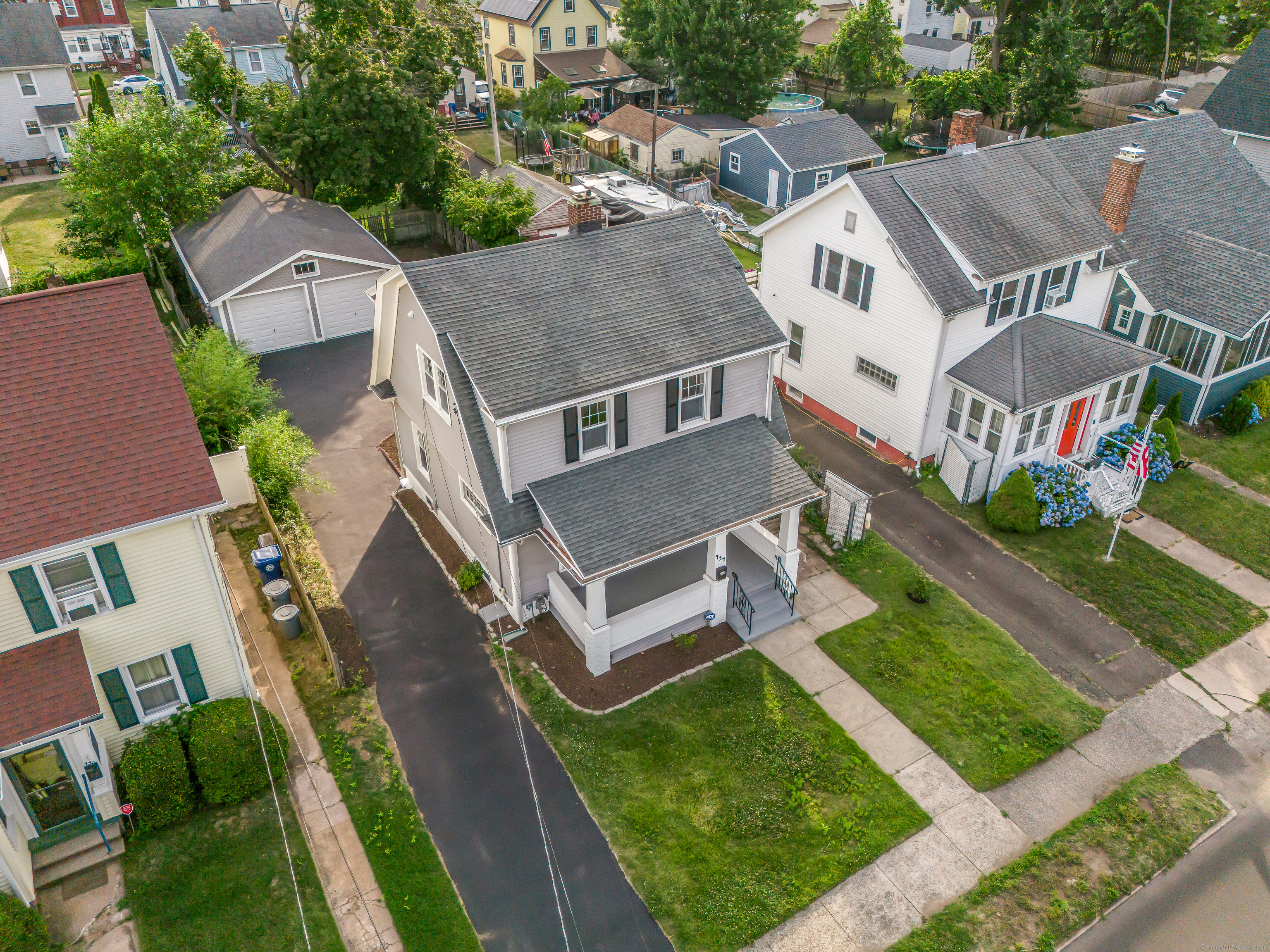 an aerial view of residential houses with yard