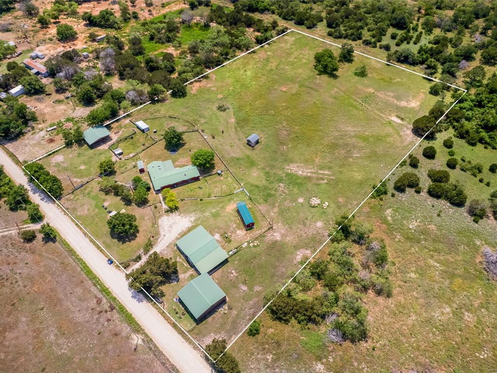 an aerial view of residential houses with yard