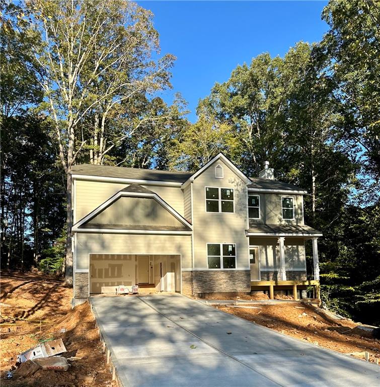 a view of house with yard and sitting area