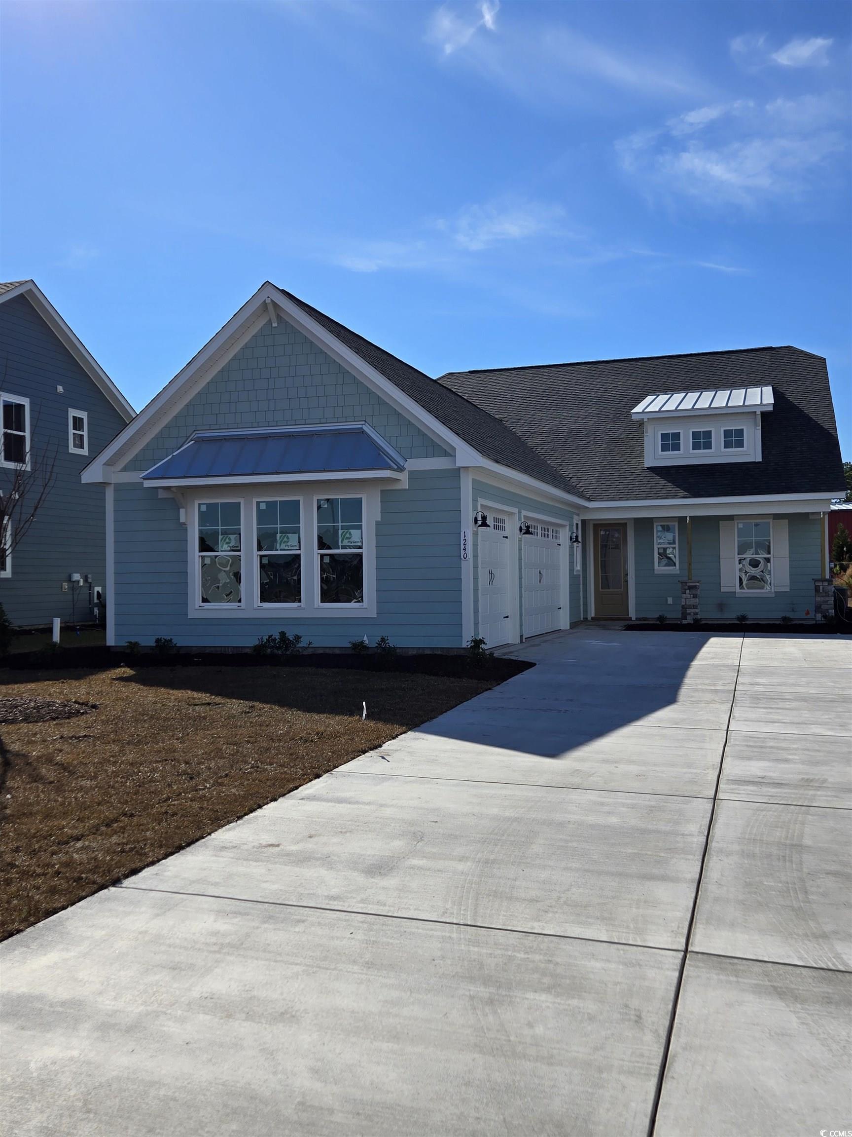 View of front facade featuring a garage