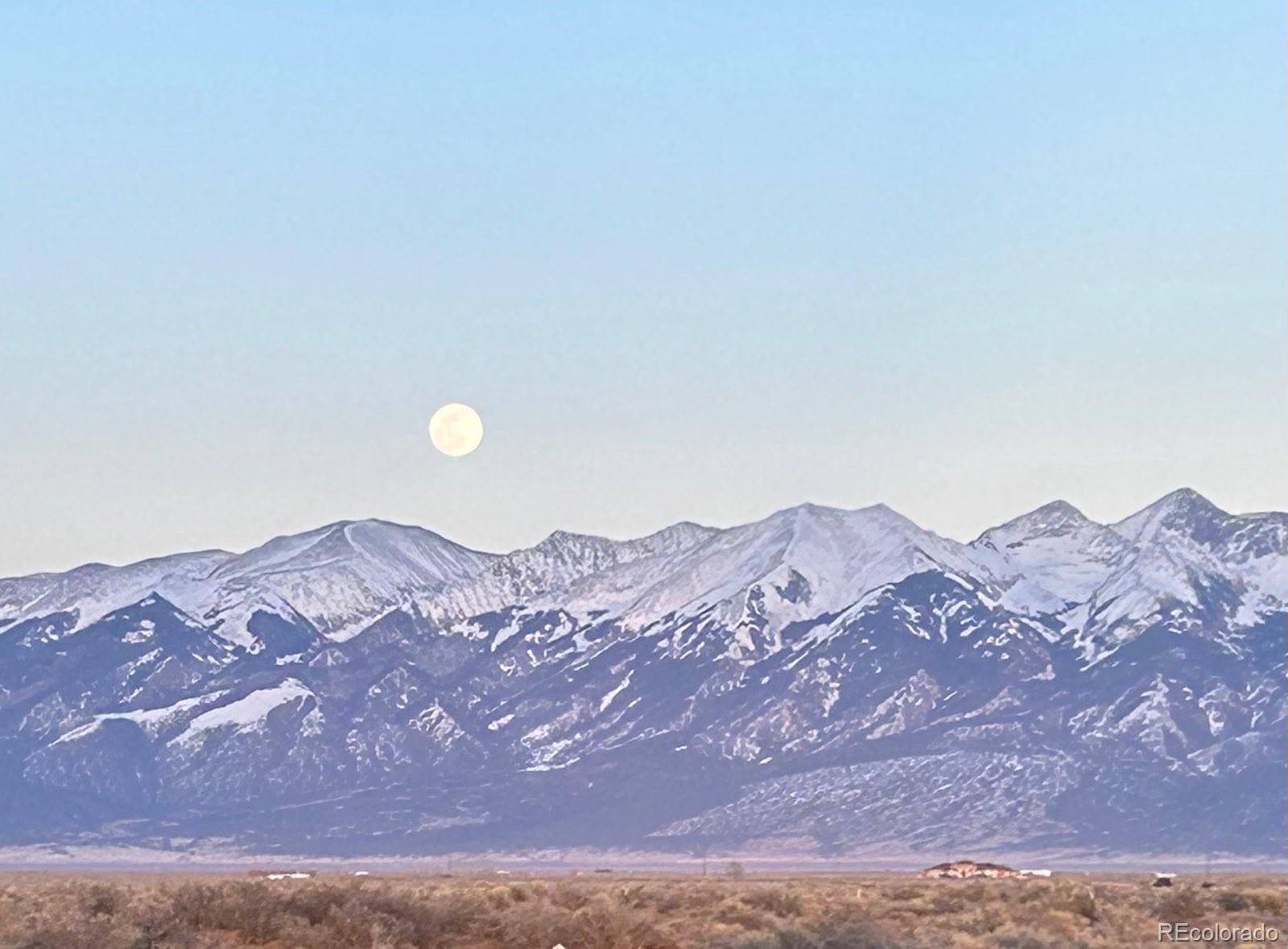 a view of a town with mountains in the background