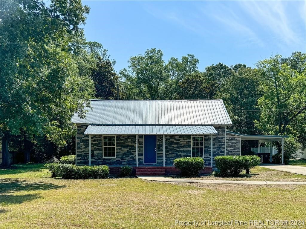 a front view of a house with garden and porch