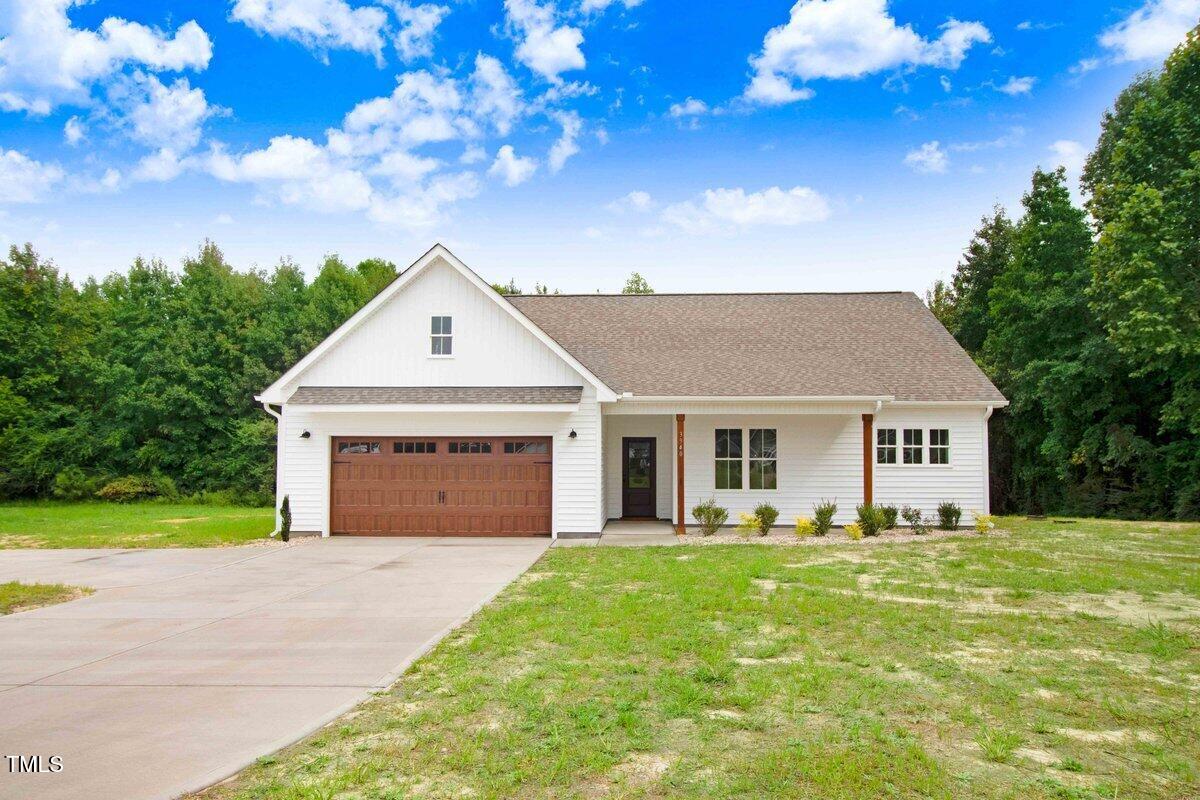 a front view of house with yard and green space