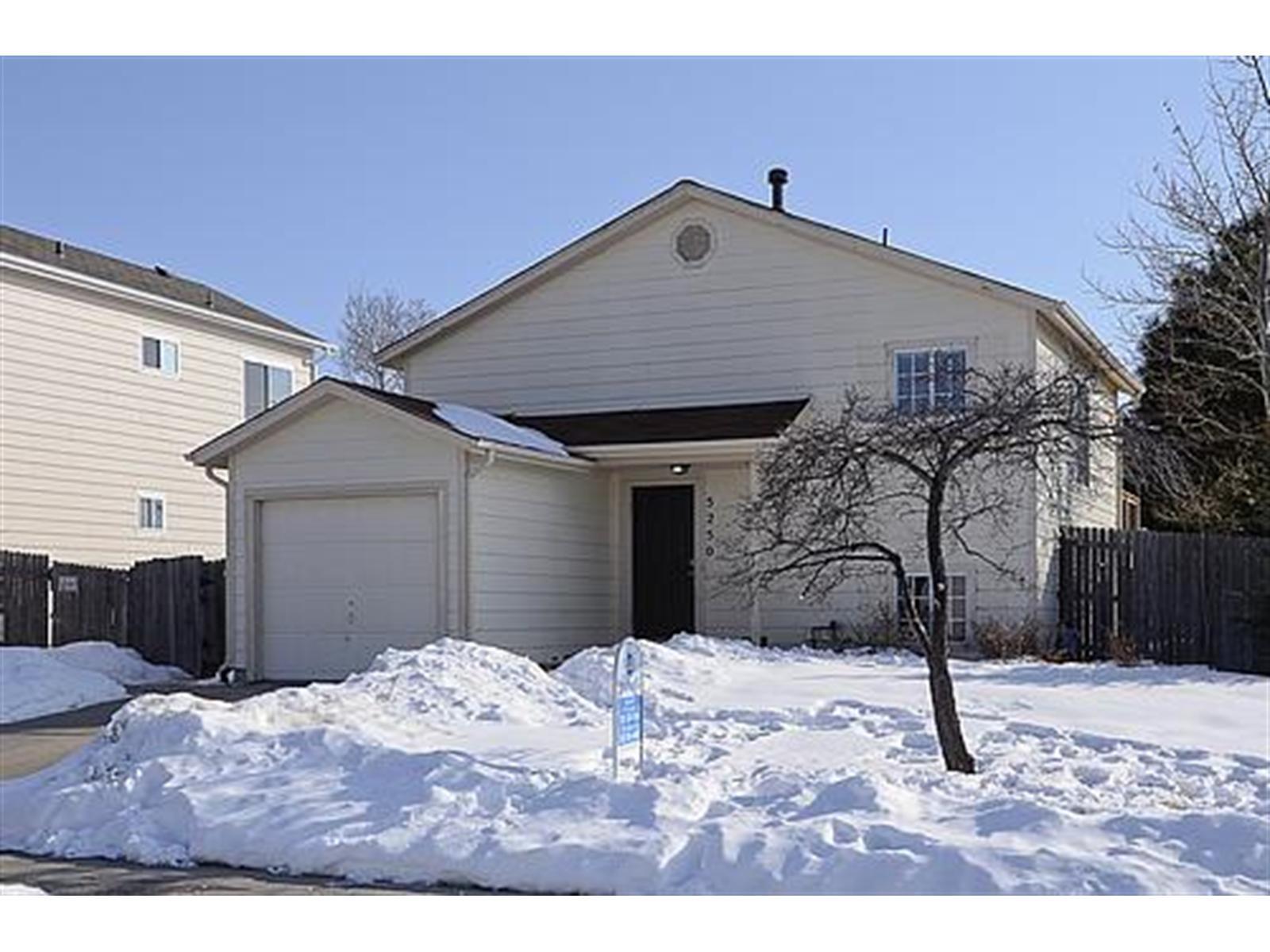 a front view of a house with parking space