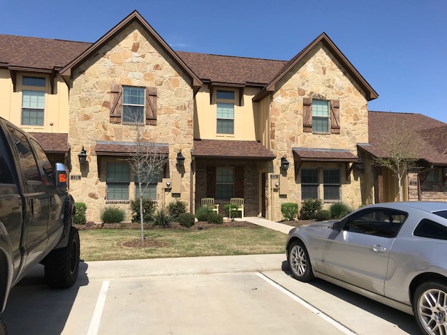 a view of a car park in front of a house