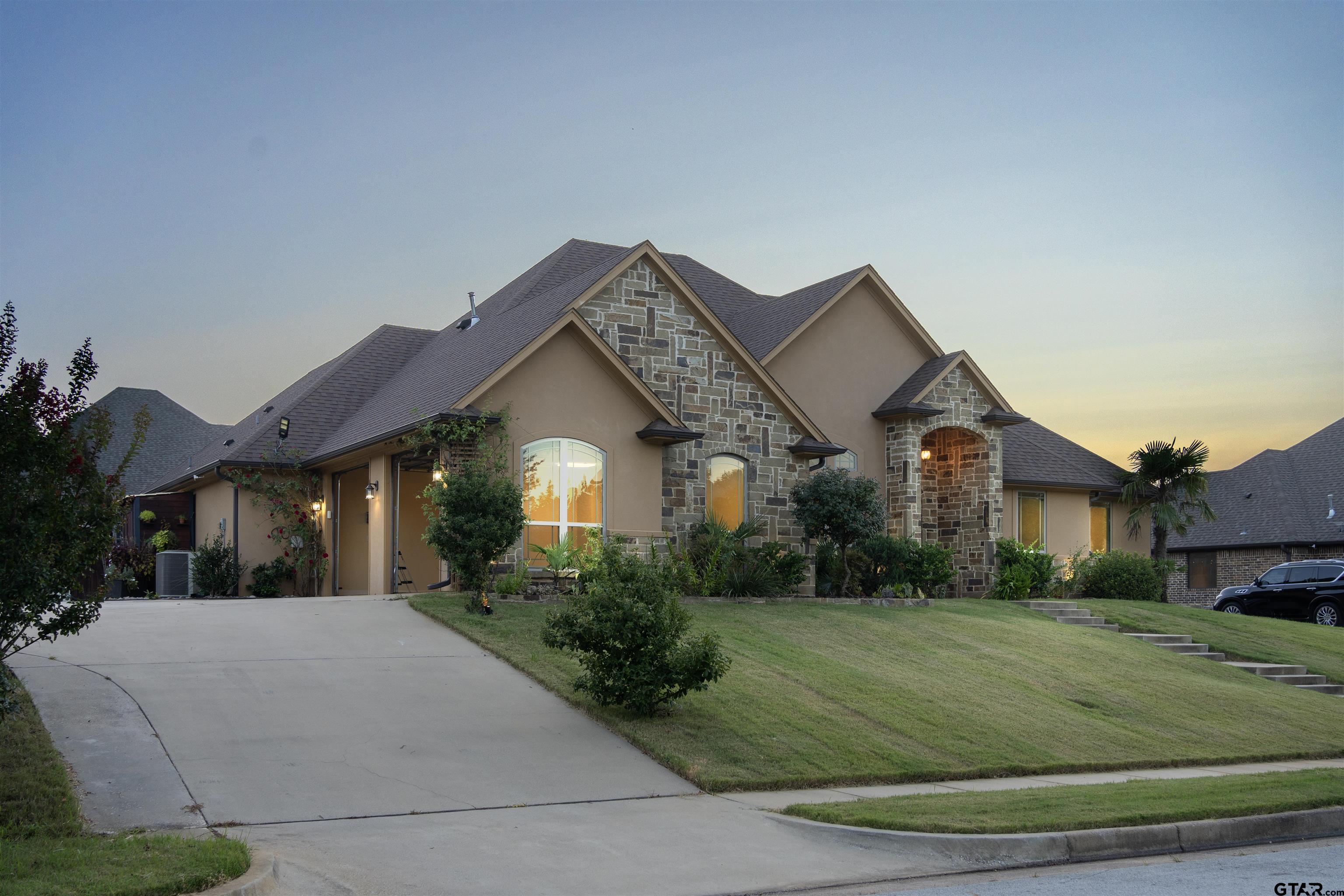 a front view of a house with a yard and garage