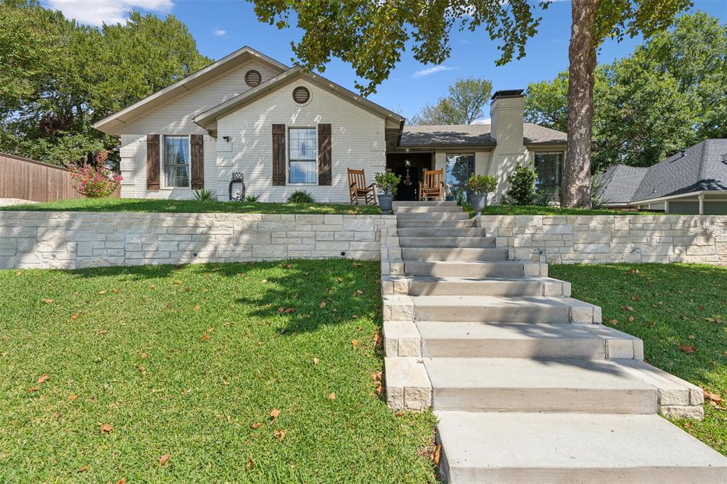 a front view of house with yard and green space