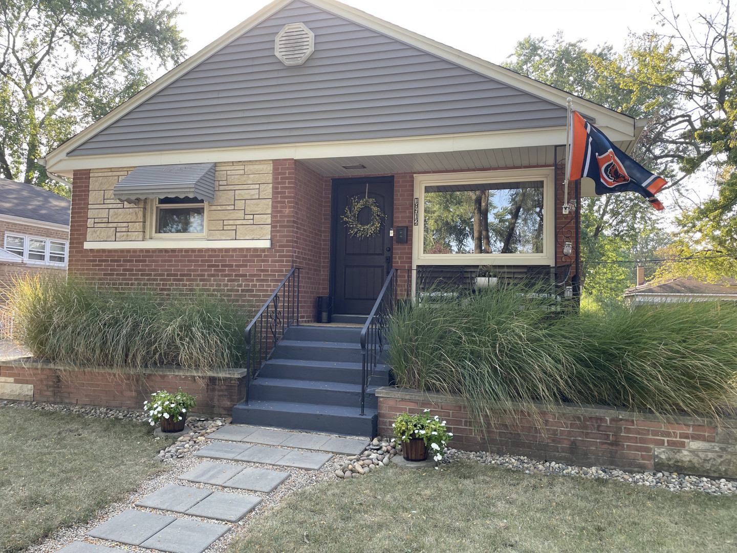 a front view of a house with garden