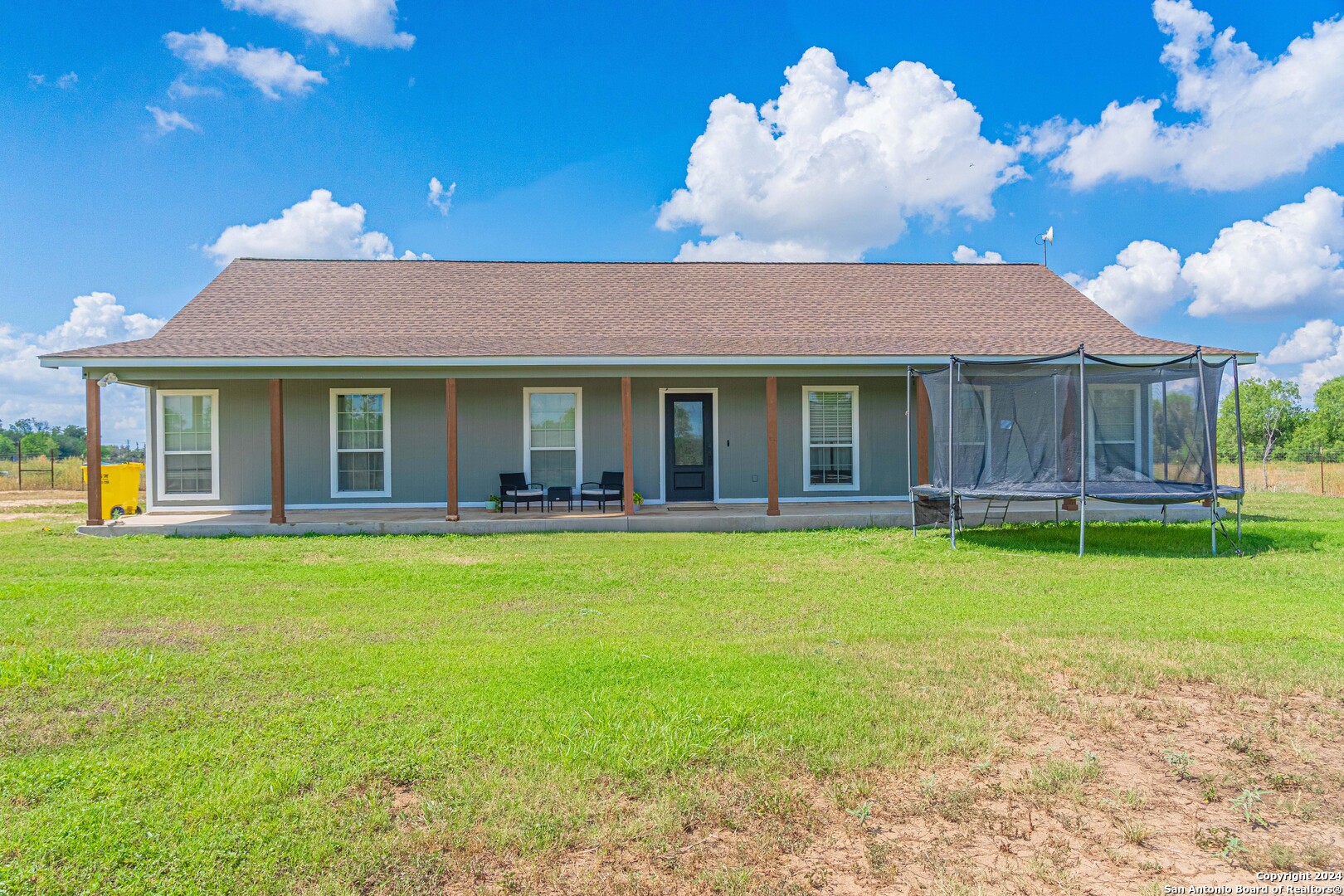 a view of a house with a backyard