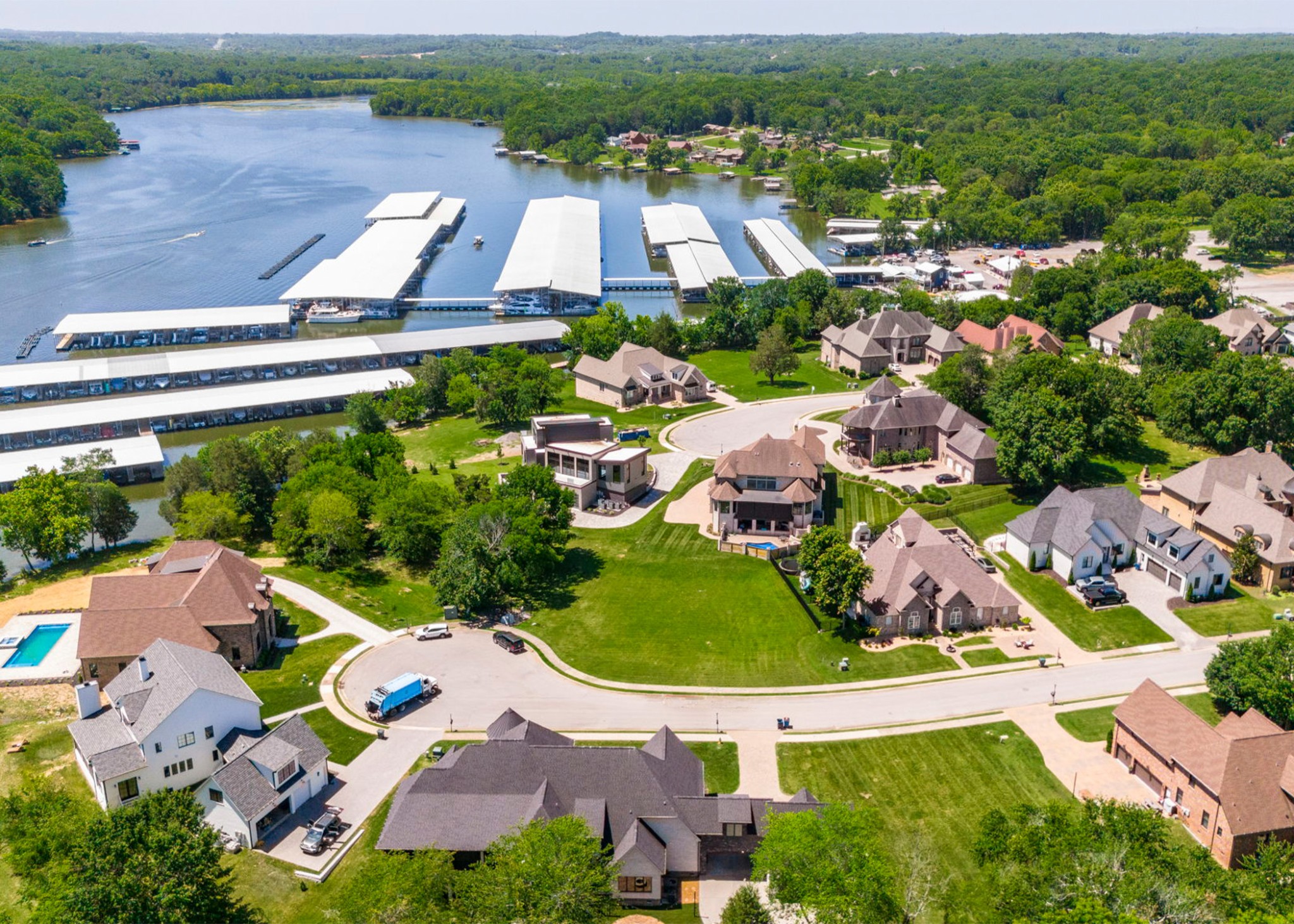 an aerial view of a house with a garden and lake view