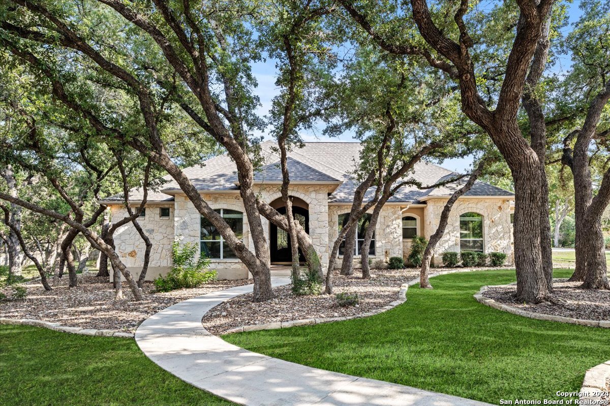 a view of a house with yard and tree s