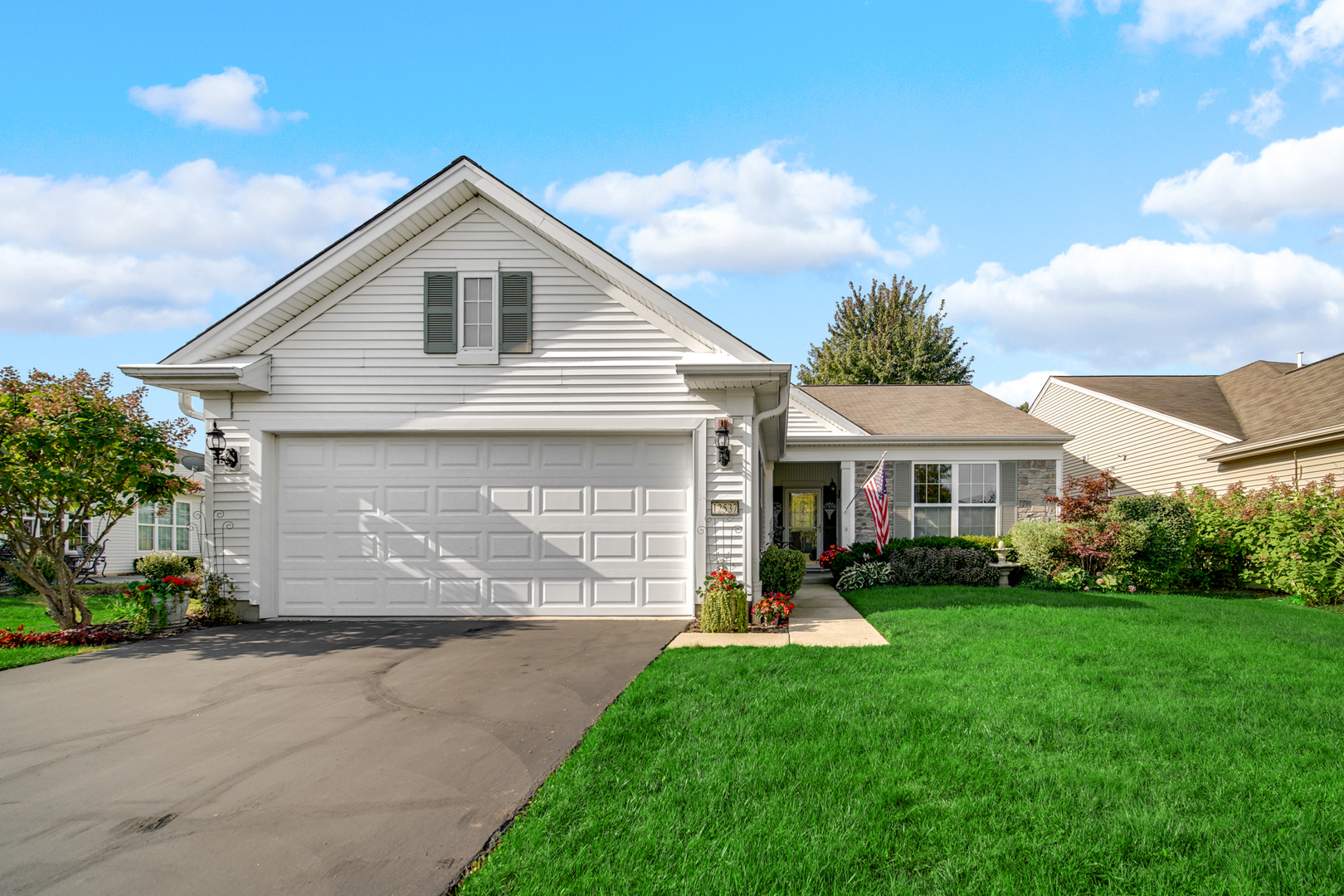 a front view of house with yard and green space