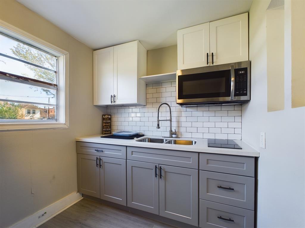 a kitchen with stainless steel appliances a stove sink and microwave