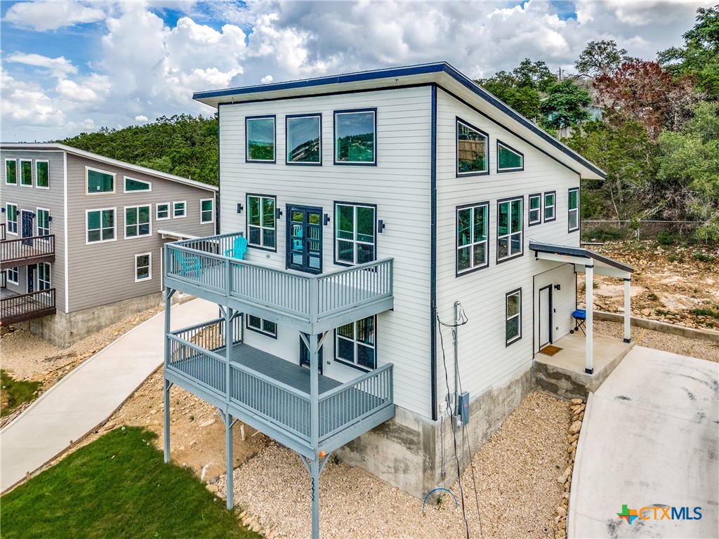 a view of a house with backyard and sitting area