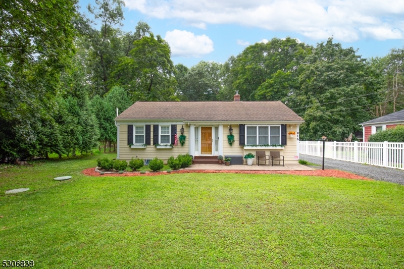 a front view of a house with a yard and porch