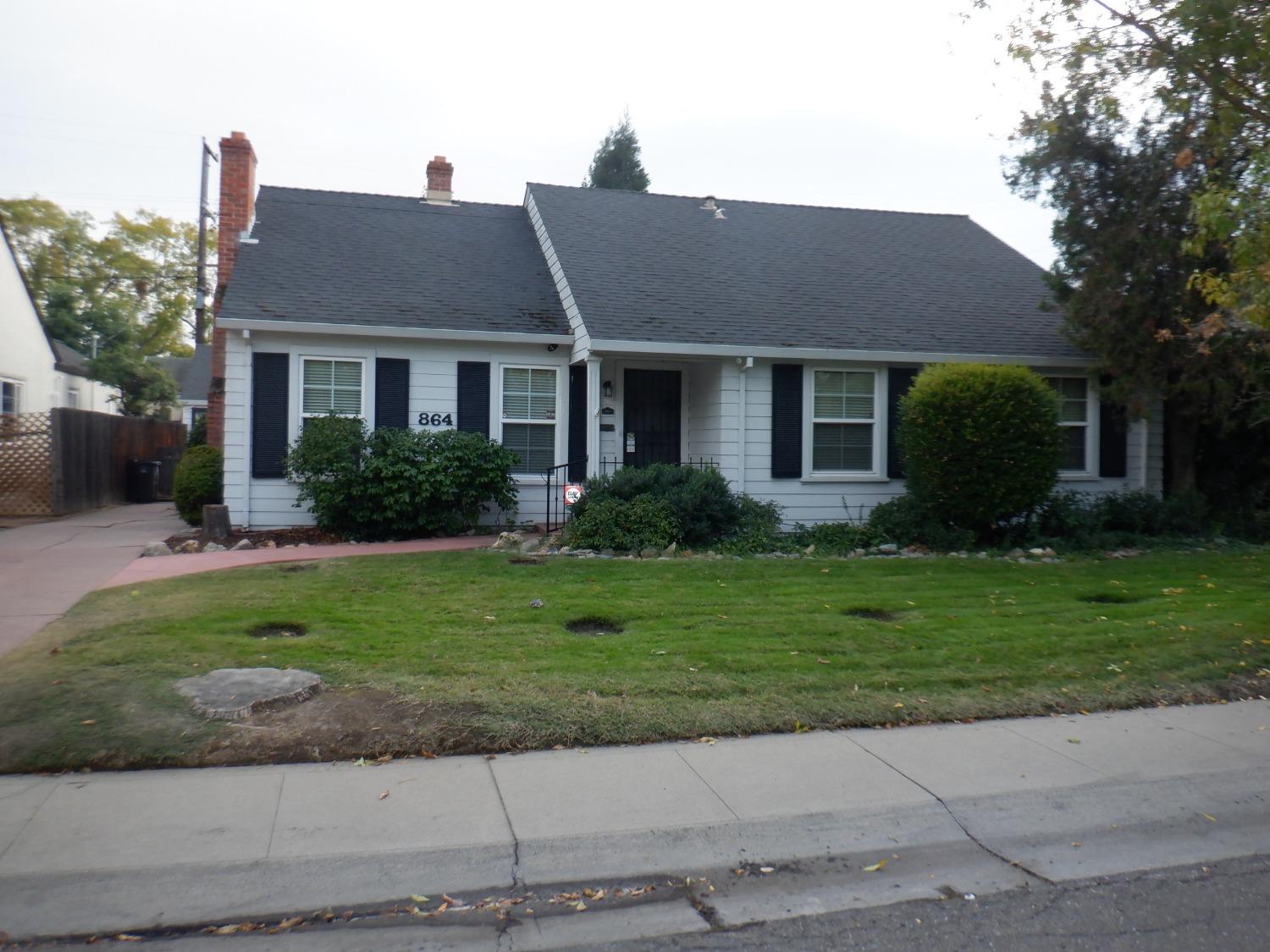 a front view of a house with a garden