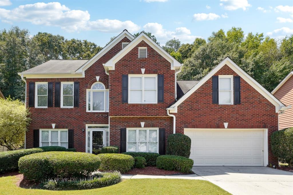 a front view of a house with a yard