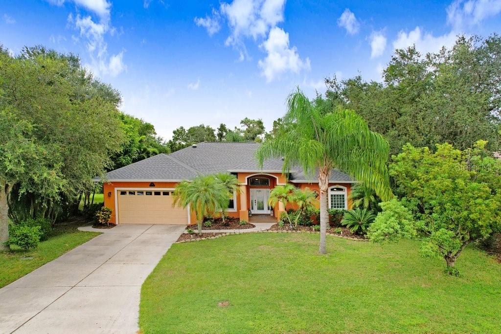 a view of a house with a backyard