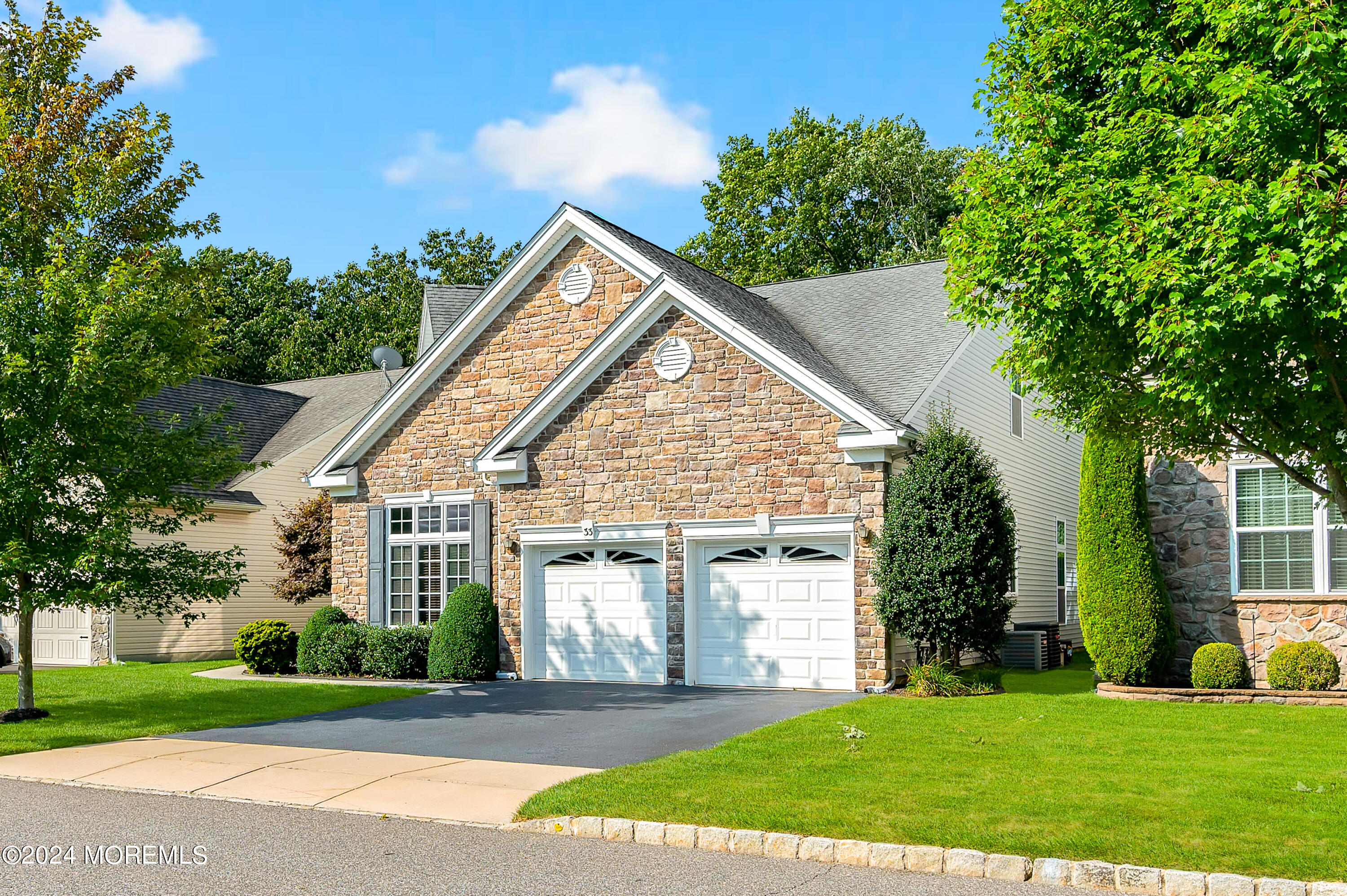 a view of a house next to a yard with big trees