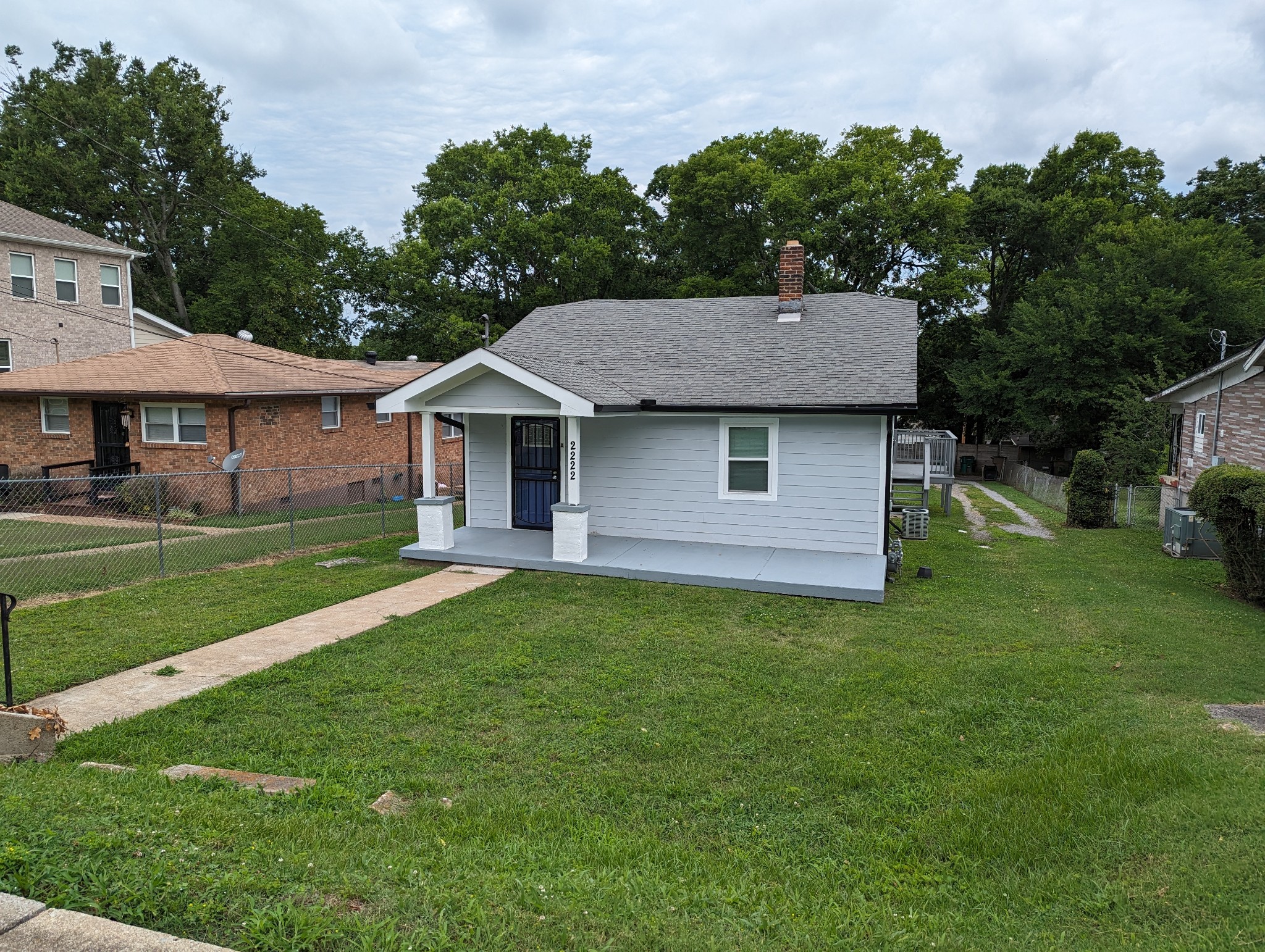 a front view of a house with a garden