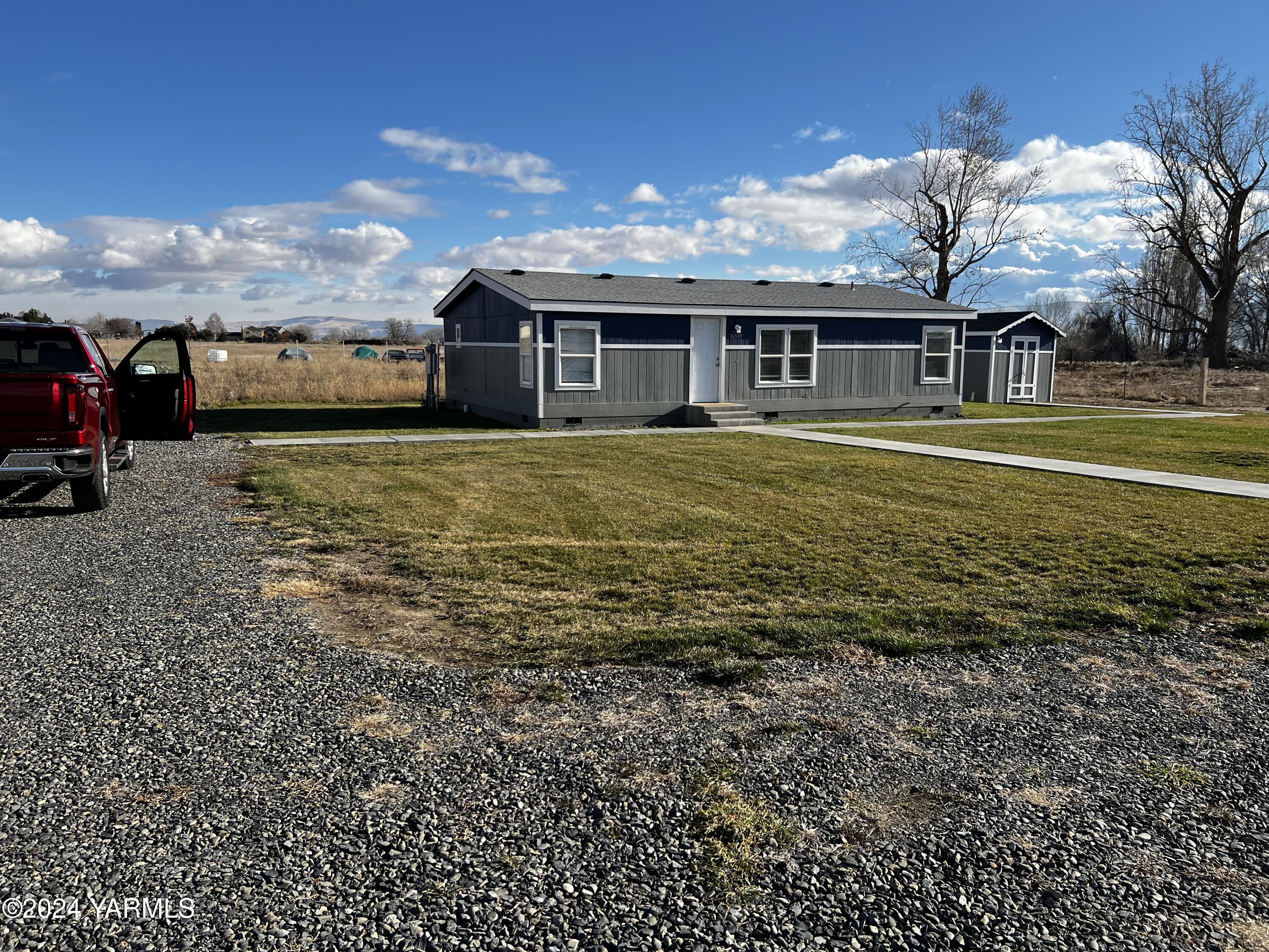 a front view of house with yard and entertaining space