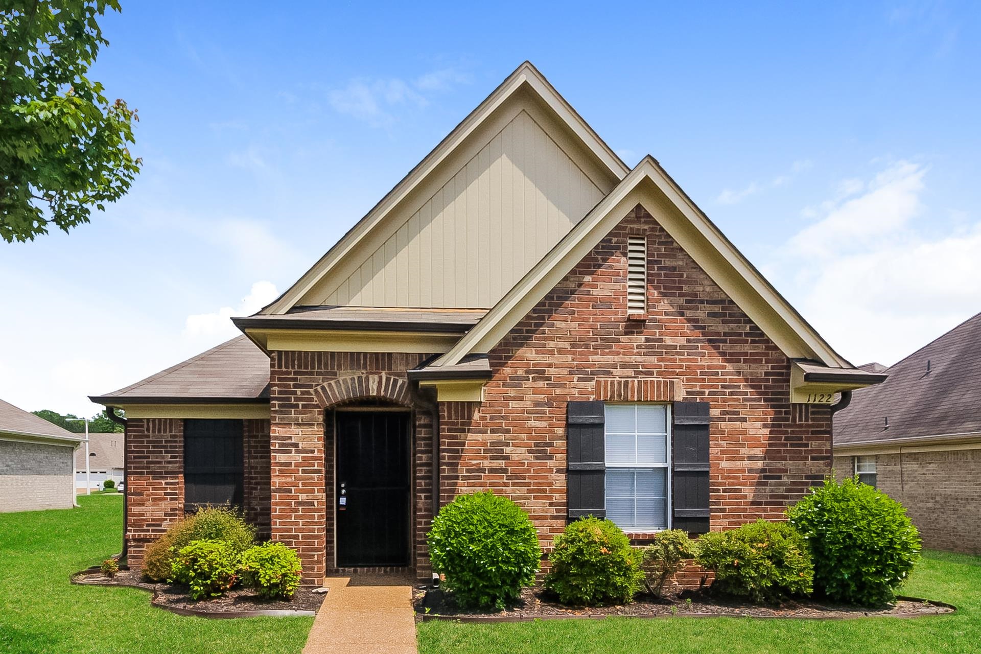 a front view of a house with a yard