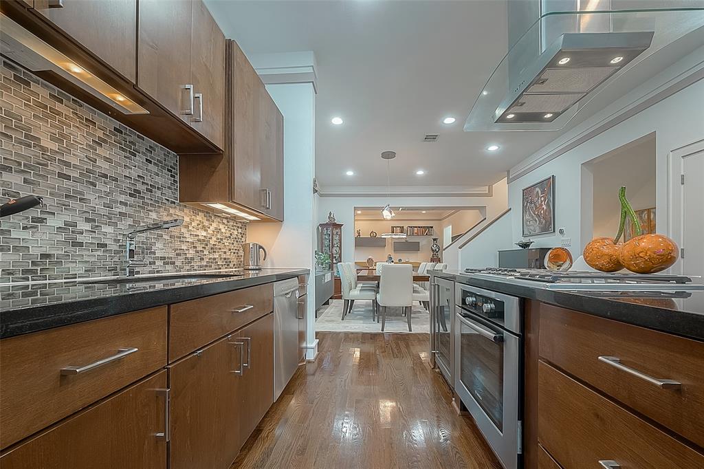 a kitchen with stainless steel appliances granite countertop a sink stove and cabinets