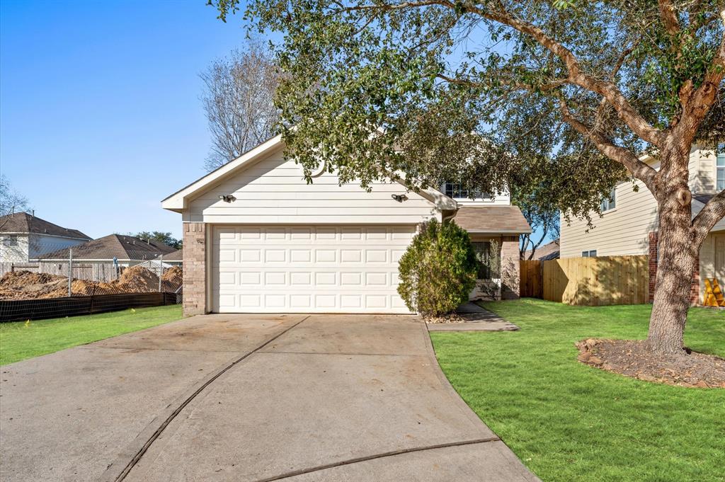 a front view of a house with a garden and yard