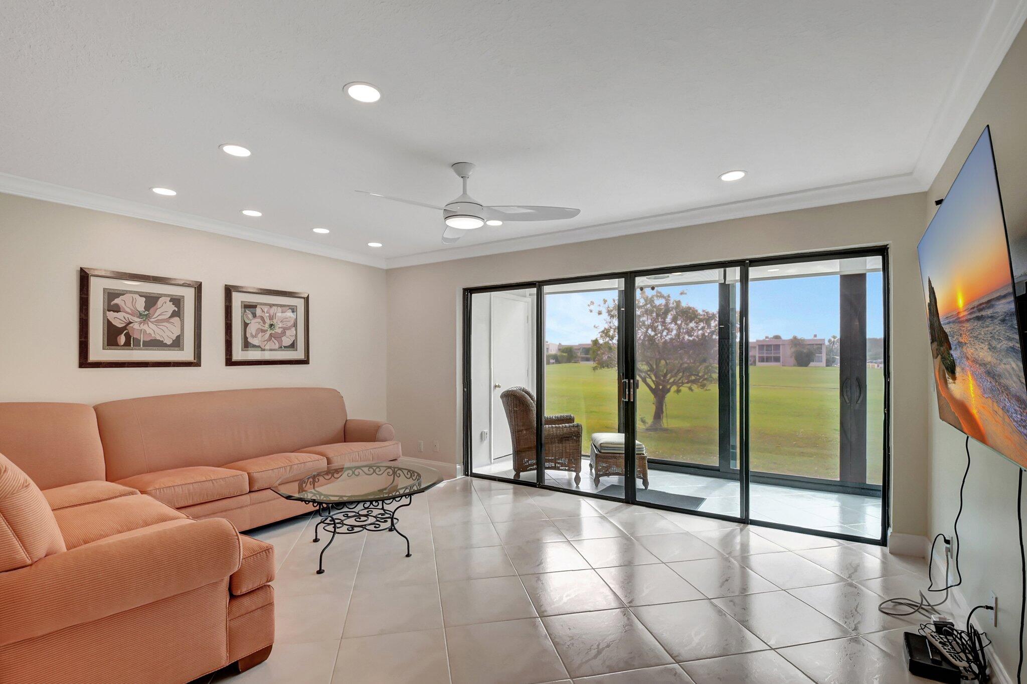 a living room with furniture and a floor to ceiling window