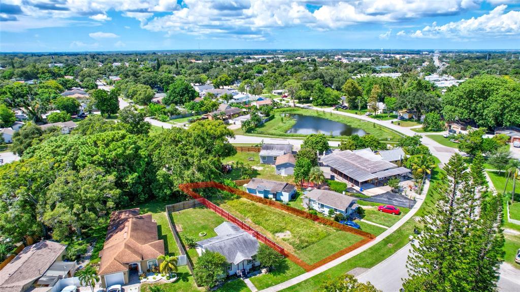 an aerial view of residential houses with outdoor space and street view