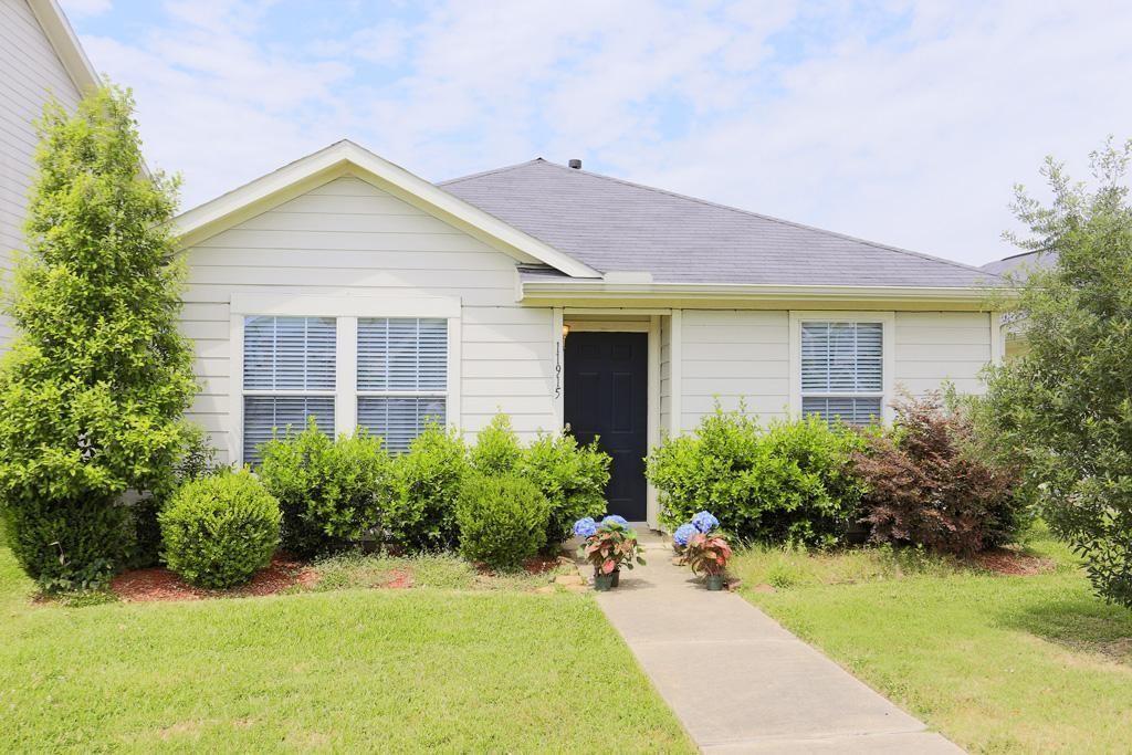 a front view of house with yard and outdoor seating