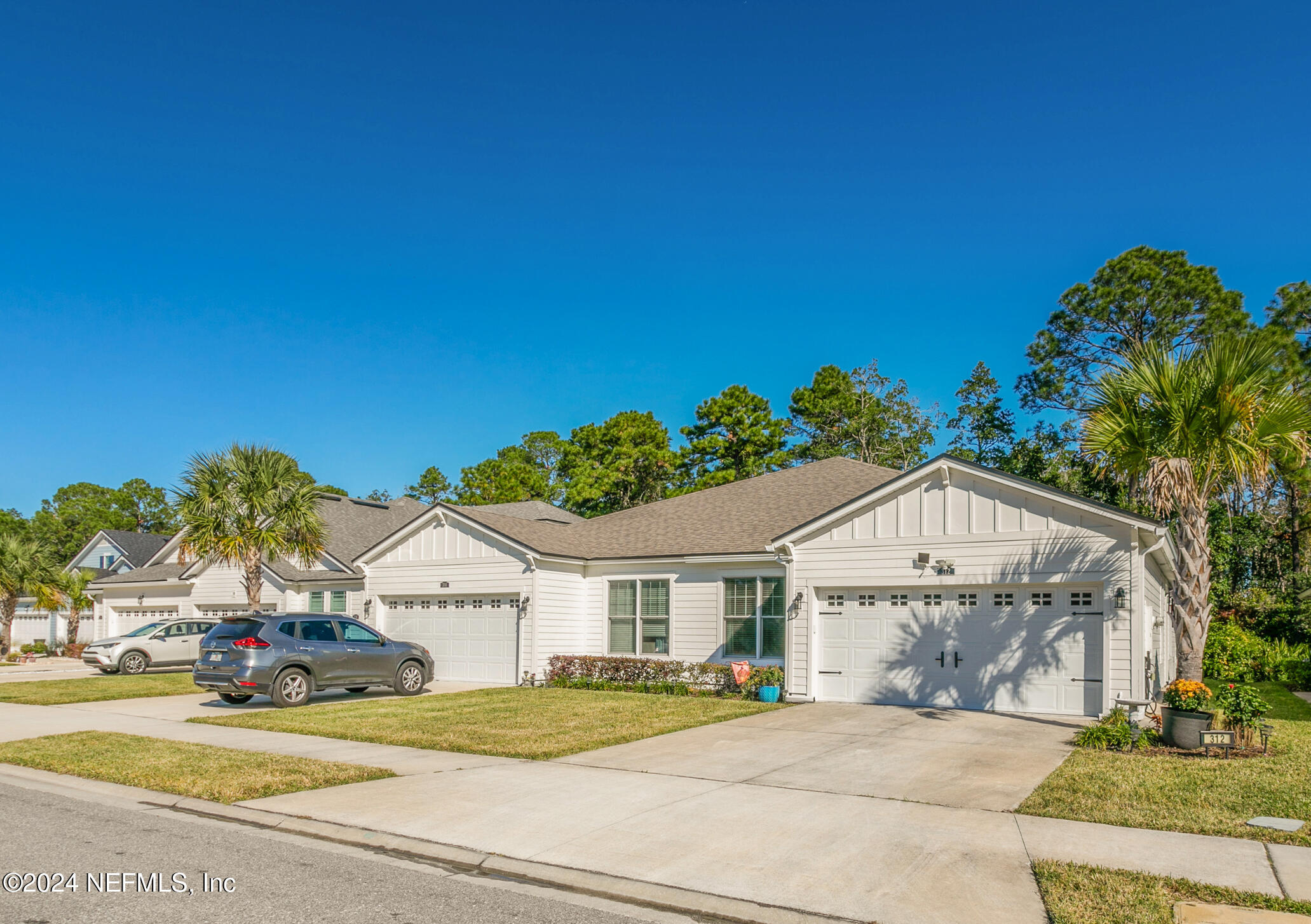 a view of a house with a yard and garage