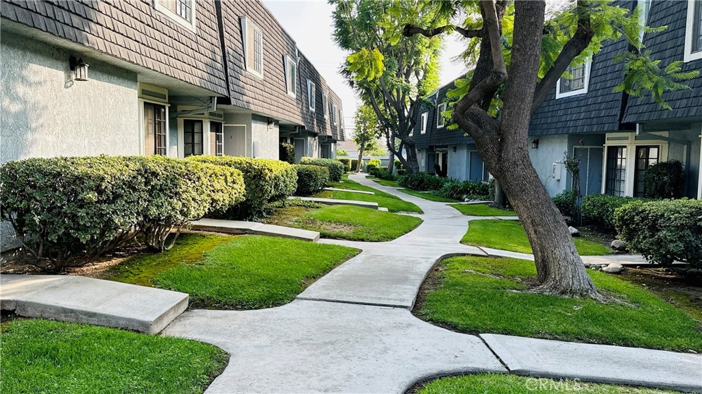 a view of a house with a yard and plants