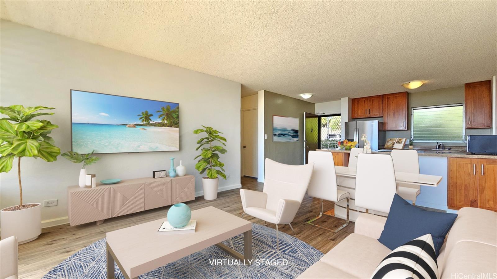 a living room with furniture and a view of kitchen