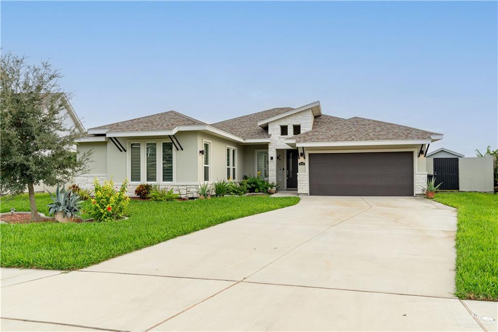 a front view of a house with a garden