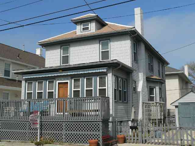 a front view of a house with a fence