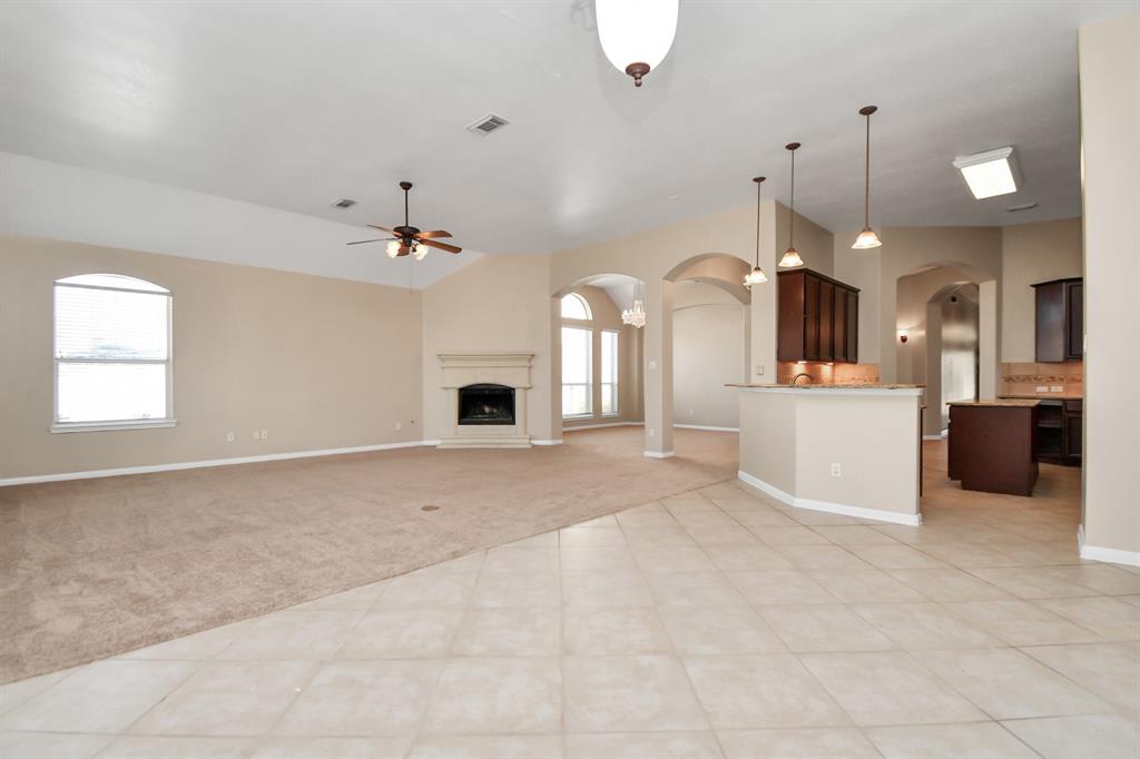 a view of a kitchen with a sink and a fireplace